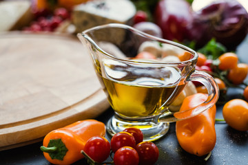 Olive oil in a glass jar. Traditional italian salad dressing. Food ingredients concept