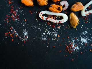Abstract seafood shrimps on dark background. Good source of omega 3 acid unsaturated fats.