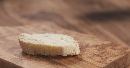 baguette slice on wooden cutting board