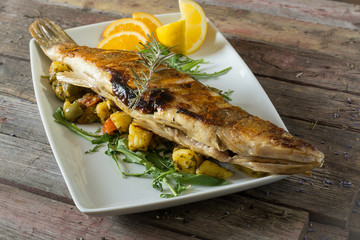 Grilled perch on a plate. on a wooden background. rustic food