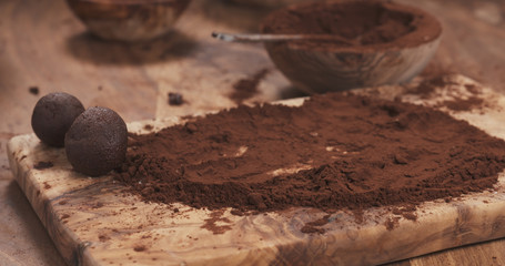 handmade truffles in cocoa powder on board