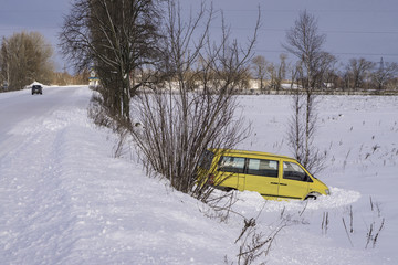 Car in ditch after winter accident. Vehicle loses control and drove off road at ice.