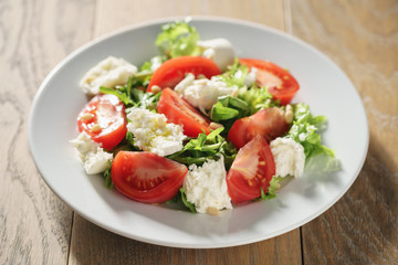 Fresh summer salad with tomatoes, arugula and mozzarella