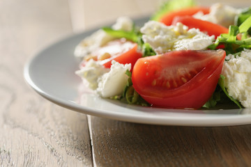 Fresh summer salad with tomatoes, arugula and mozzarella