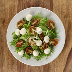 Caprese salad variation with kumato tomatoes and frillies leaves