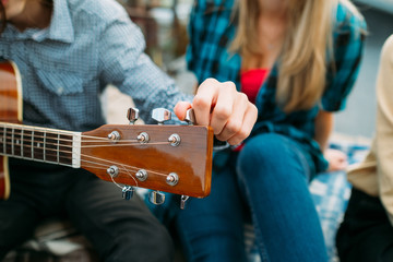 Man tuning guitar. Fretboard closeup. Music leisure hobby. Performer vocation