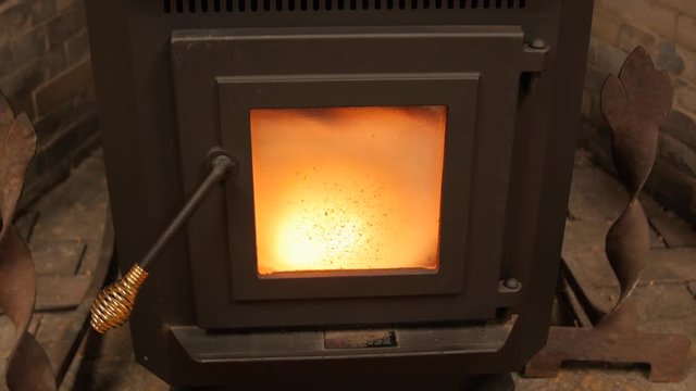 Dolly shot of a pellet stove heating a room