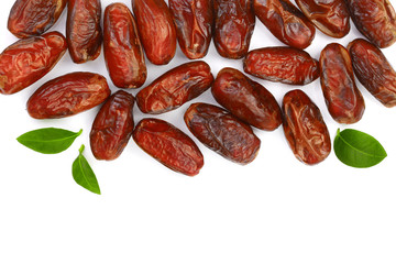 dry dates with green leaves isolated on white background with copy space for your text. Top view. Flat lay pattern