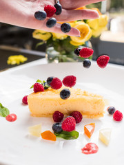 dessert cheesecake berries decoration concept. lifestyle of confectioner. creation process.