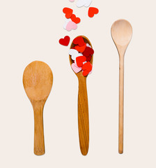 Valentine background, paper hearts and wooden spoons over white isolated background
