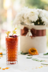 bloody mary alcoholic beverage against hangover concept. morning after party. floral decoration.