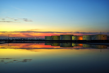 White oil tank, water reflection, beautiful evening