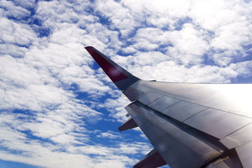 The wings of the plane float above the clouds and the sky is beautiful.