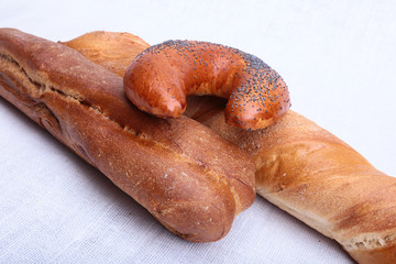 Many mixed breads and muffins on white background.