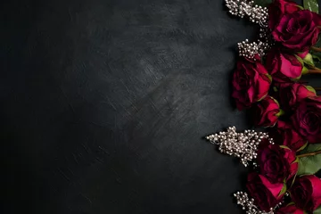 Burgundy or wine red roses and silver decor on dark background. True love passion and desire. Copy space concept © Photodrive