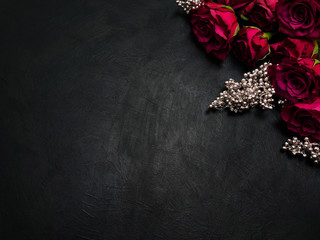 Burgundy or wine red roses and silver decor on dark background. True love passion and desire. Copy...