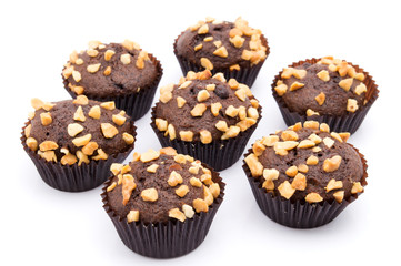 Group of chocolate muffins with nuts crumbs isolated on white background