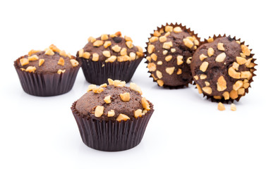 Group of chocolate muffins with nuts crumbs isolated on white background