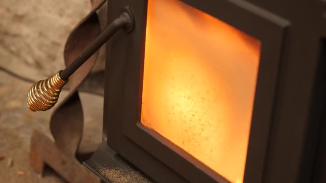 Dolly shot of pellet stove heating a room in winter
