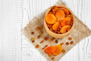 Many useful dried apricots and raisins. Top view. The concept is healthy food, vegetarianism, diet, vitamins.
