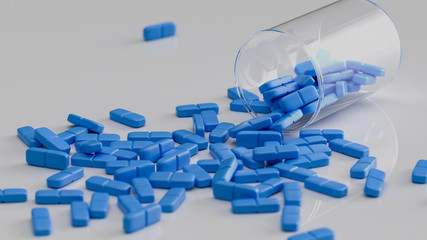 Blaue Tabletten liegen verteilt auf einem Tisch - obrazy, fototapety, plakaty