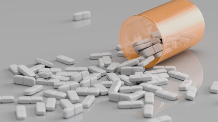 Weiße Tabletten liegen verteilt auf einem Tisch