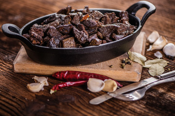 braised beef and lamb meat, liver, lungs and heart dish in black iron cast heavy dish
