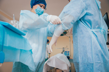 Group of surgeons in operating room with surgery equipment.