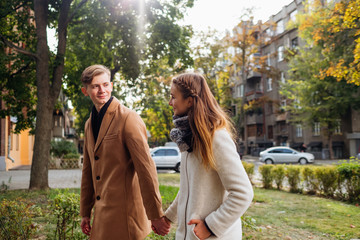 Fototapeta premium Young adults in romantic relationship. Couple holding hands on a date. Happy together. Free space concept