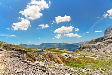 Stony track in mountains of Picos de Europa and tourists, the vicinity of Fuente De