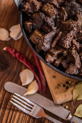 braised beef and lamb meat, liver, lungs and heart dish in black iron cast heavy dish