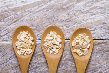 Fototapeta na wymiar oatmeal straws in bowl on wood