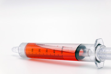 Syringe with blood isolated on white