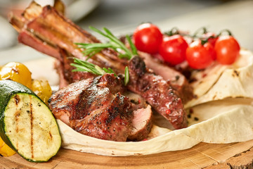 Closeup grilled meat and courgette. Closeup grilled meat and courgette in lavash on wooden table.