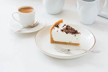Homemade Cheesecake with chocolate and a cup of coffee on a white background.
