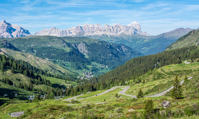 Fototapeta na wymiar mountain landscape in summer in Trentino Alto Adige. View from Passo Rolle, Italian Dolomites, Trento, Italy. Mountain road - serpentine in the mountains Dolomites, Italy