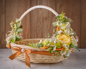 Fototapeta na wymiar Beautiful decorative basket with flowers to celebrate Easter