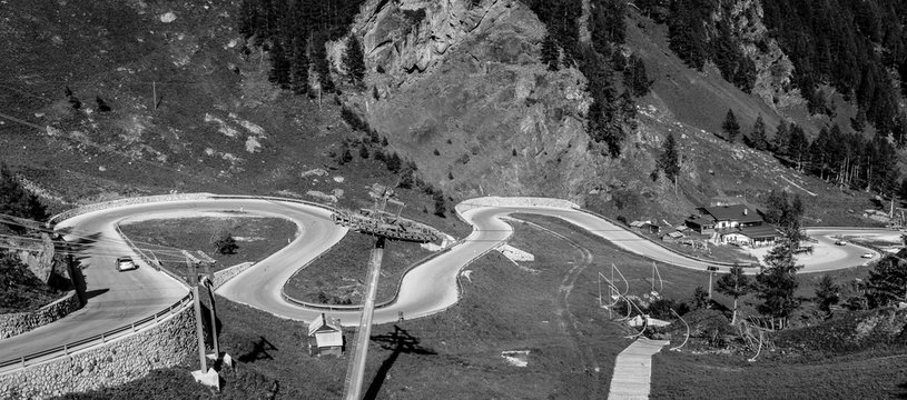 Fototapeta mountain landscape in summer in Trentino Alto Adige. View from Passo Rolle, Italian Dolomites, Trento, Italy. Mountain road - serpentine in the mountains Dolomites, Italy. Image in Black and white