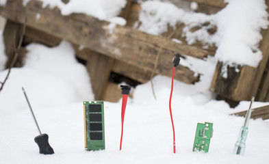 computer boards inserted in the snow in winter