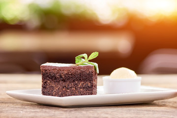 Slice of belgian chocolate cake with decoration. Close up side view chocolate piece of cake.
