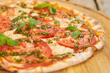 Close up tomato pizza with basil. Sprinkled basil on tomato pizza, macro view.