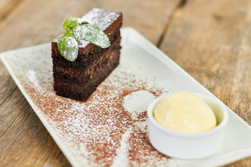 Cake with mint floured with white powder. Fucused piece of cake.