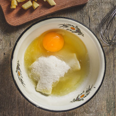 Preparation of raw sweet dough - egg, flour, sugar, vanilla mix in a bowl with a whisk