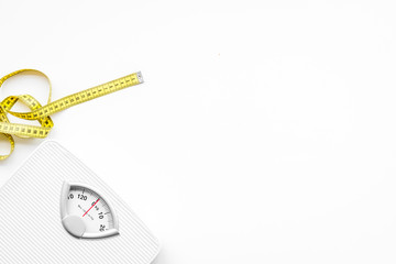 Slim concept. Scale and measuring tape on white background top view space for text