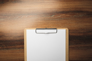 Wood clipboard with empty white paper on wooden table