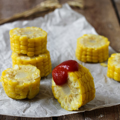 boiled corn slices with tomato sauce - a useful snack