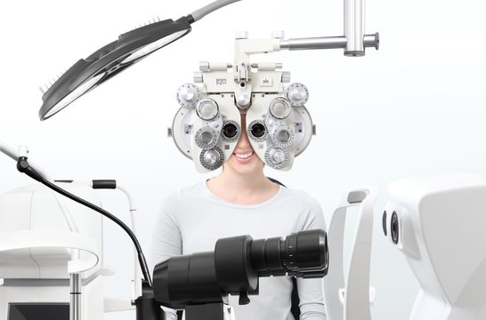 optometrist exam, eyesight  woman patient with phoropter in optician office