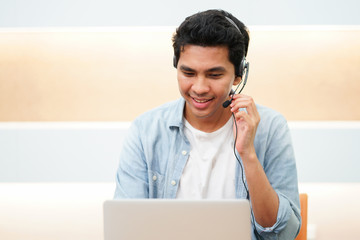 close up call center asian man talking on headset with customer for good experience service , telemarketing working concept