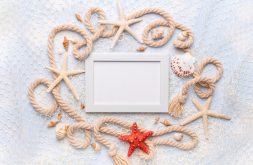 Fototapeta na wymiar Summer Holiday concept with star fish, sea shells, fishing net and rope on blue background, flat lay, copy space for text