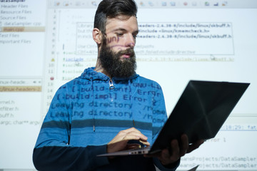 programmer courses at education center. Man holding a laptop while lecturing on information and...